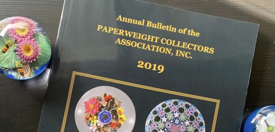 Annual Bulletin Cover with Paperweights